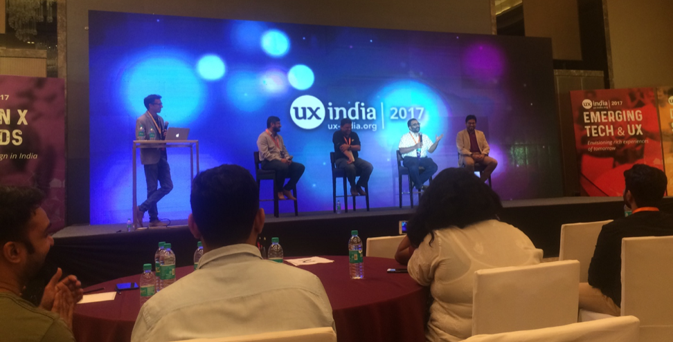 Panelists on stage giving their ideas about the necessary skills for a UX designer to be successful